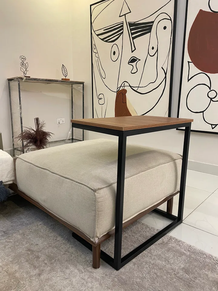 Wood-top accent table with black metal frame in a furnished room