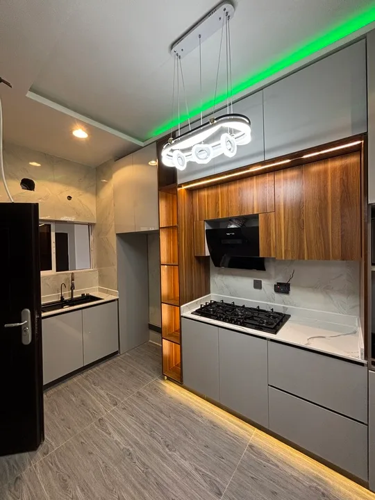 Kitchen interior with wood cabinetry, white units and pendant lighting