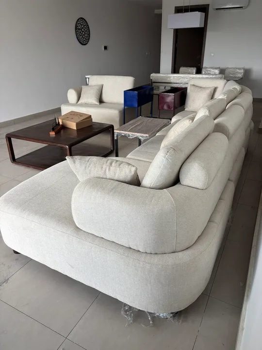 Furnished living room with cream seating and a dark coffee table